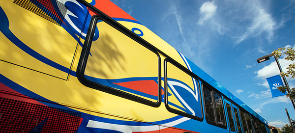 "Close up of Jayhawk face painted on side of a KU bus"